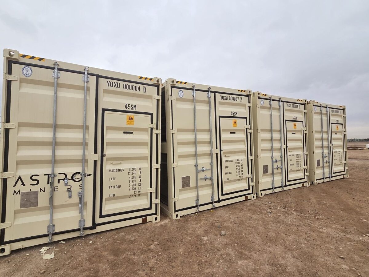 Row of branded Astro Miners testing containers serving West Texas mining sites
