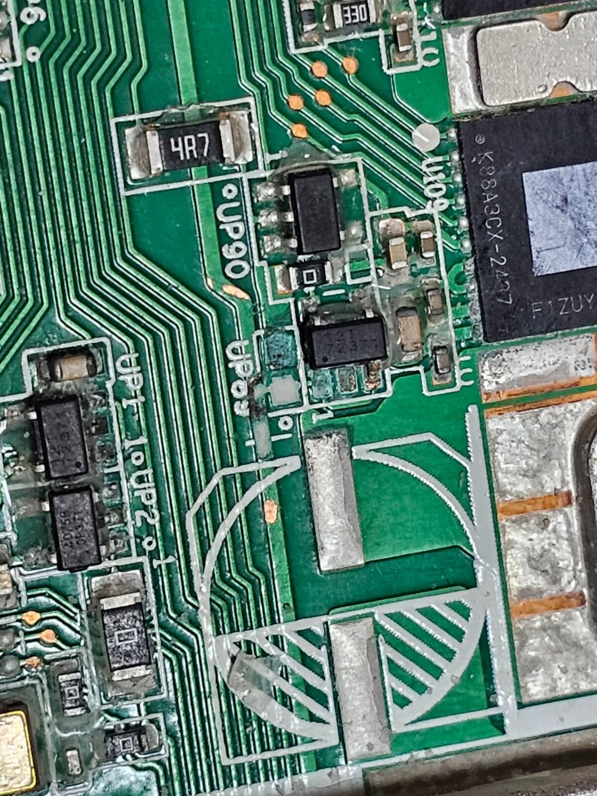 Macro close-up of ASIC chips on a bitcoin miner hashboard during repair